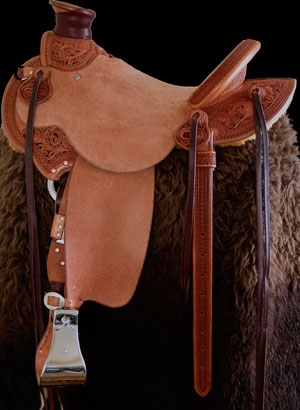 Light weight Lady's Wade Saddle with Custom copper rose and blue bells floral tooling with hand painted dyed background all dallied in a Vaquero Lace border.  Contact us about a saddle made just for you like this one.